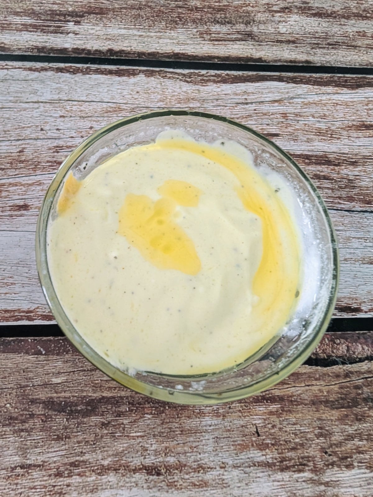 Whisked Greek yogurt Dijon dressing in a small bowl.