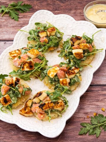 Leftover rice transformed into crispy rice rounds with fresh arugula, citrus, and halloumi.