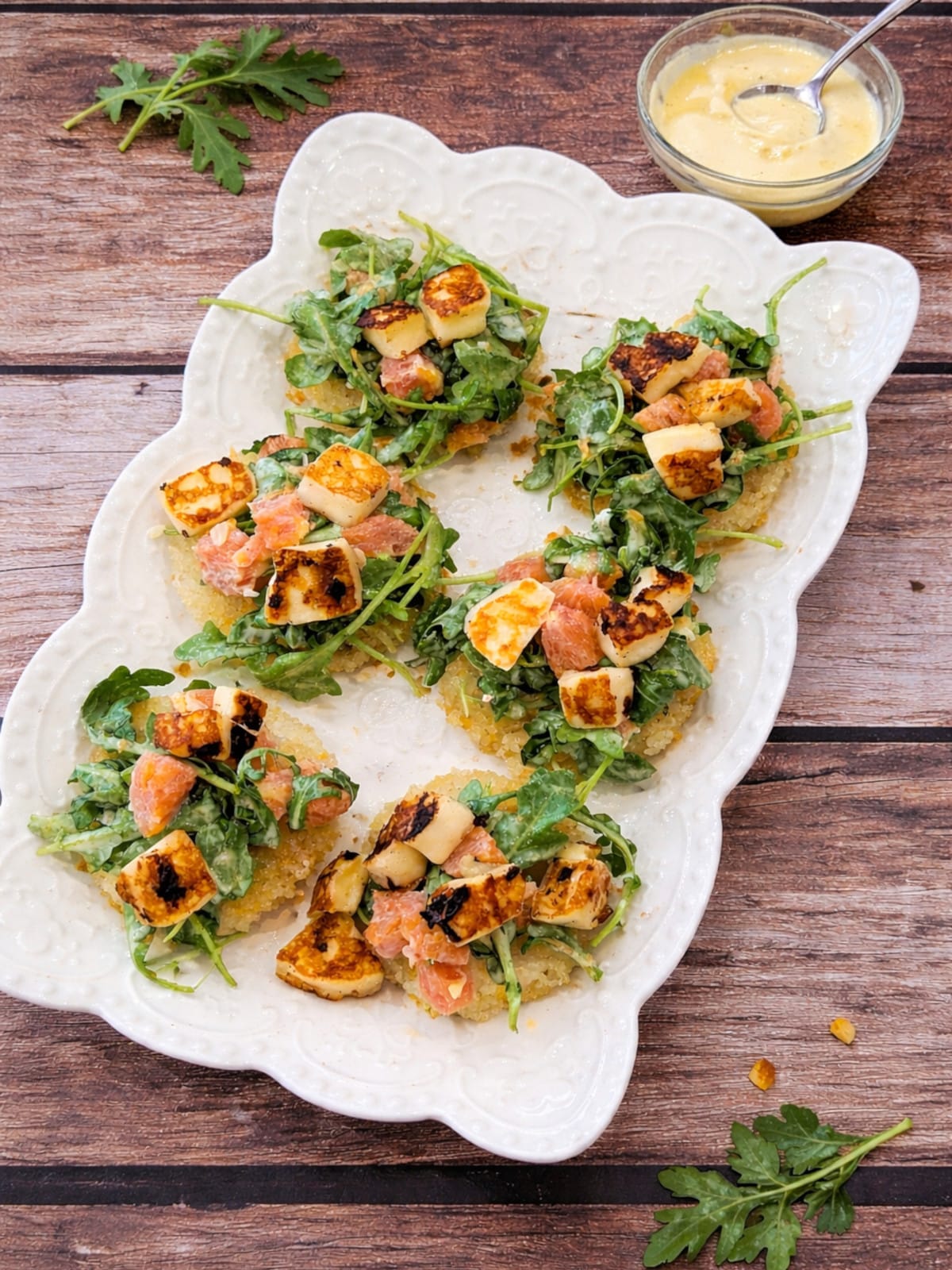 Leftover rice transformed into crispy rice rounds with fresh arugula, citrus, and halloumi.