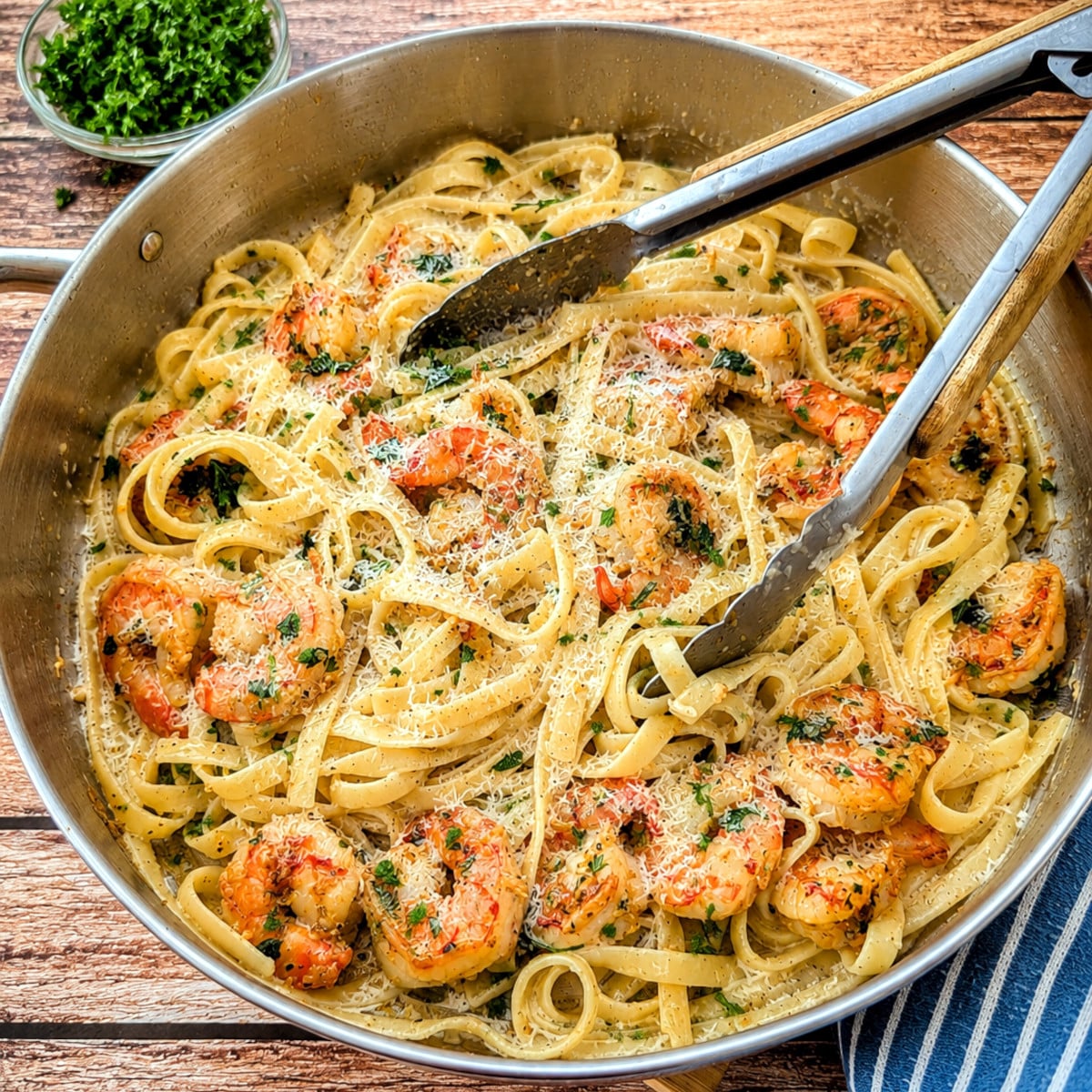 Creamy garlic butter shrimp pasta topped with Parmesan cheese.