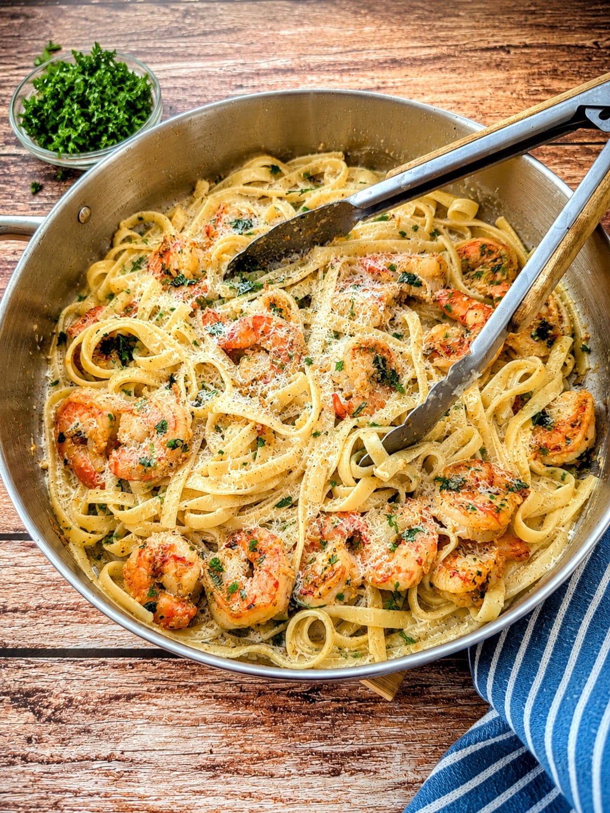 Creamy garlic butter shrimp pasta topped with Parmesan cheese.