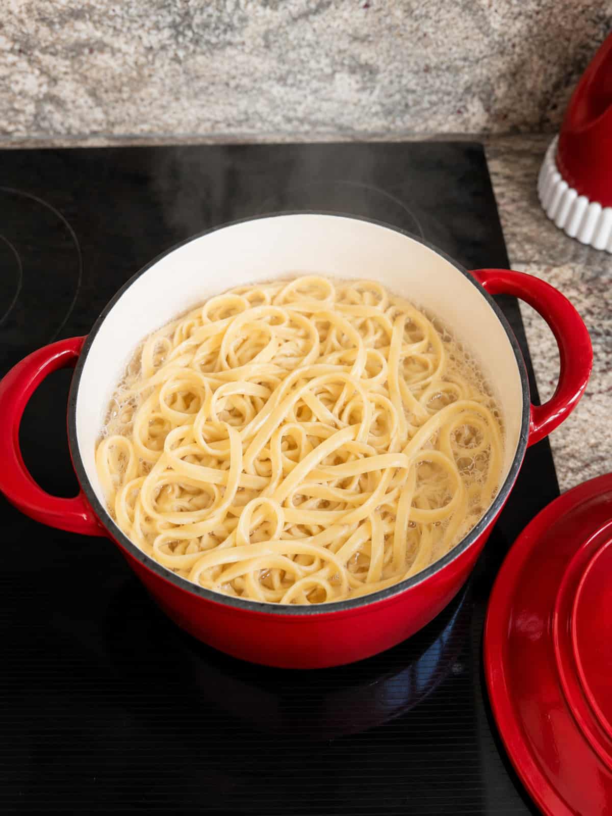 cooked al dente pasta in a pot of water on the stove.