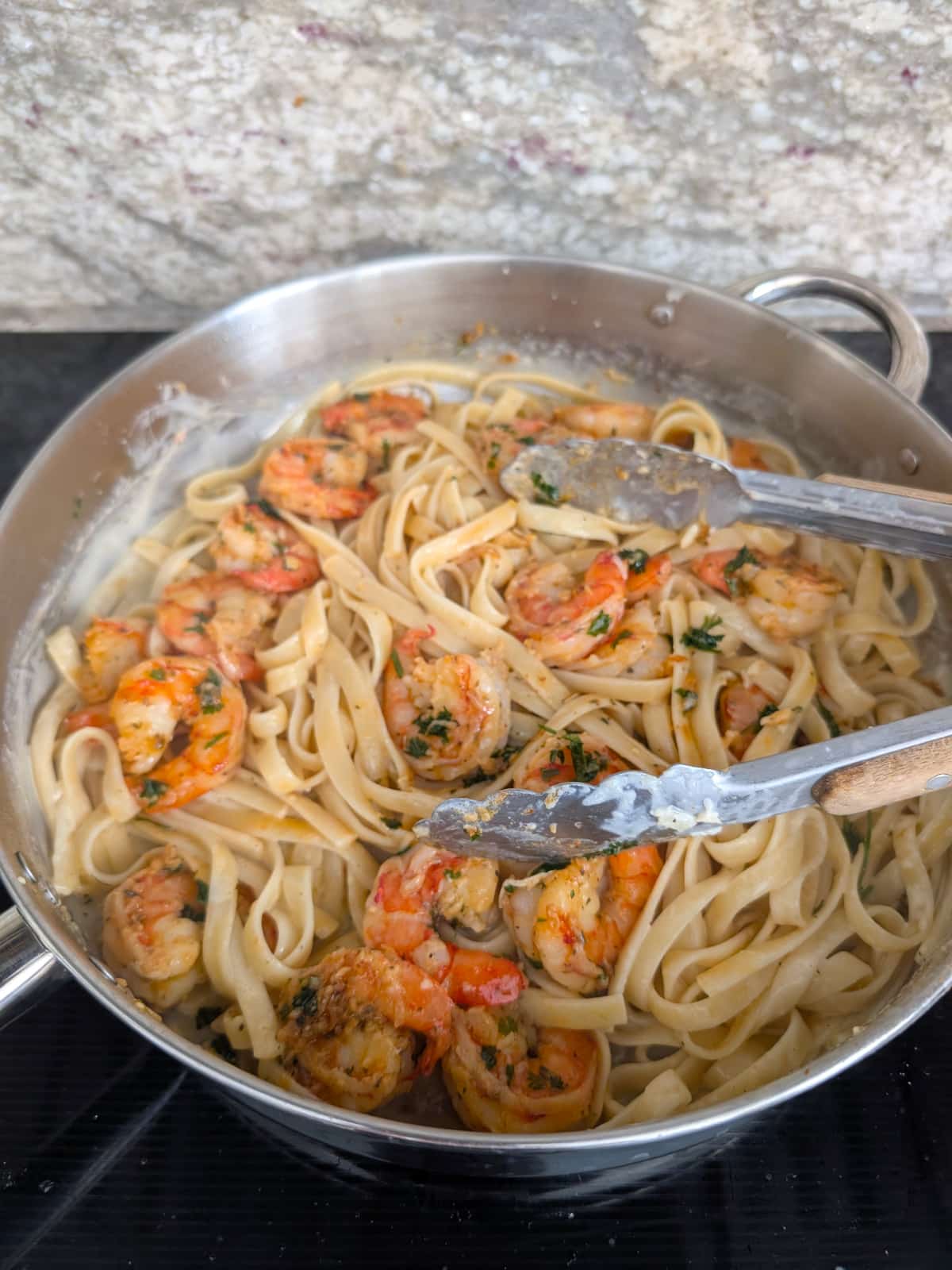 shrimp and cooked pasta added to garlic butter sauce.