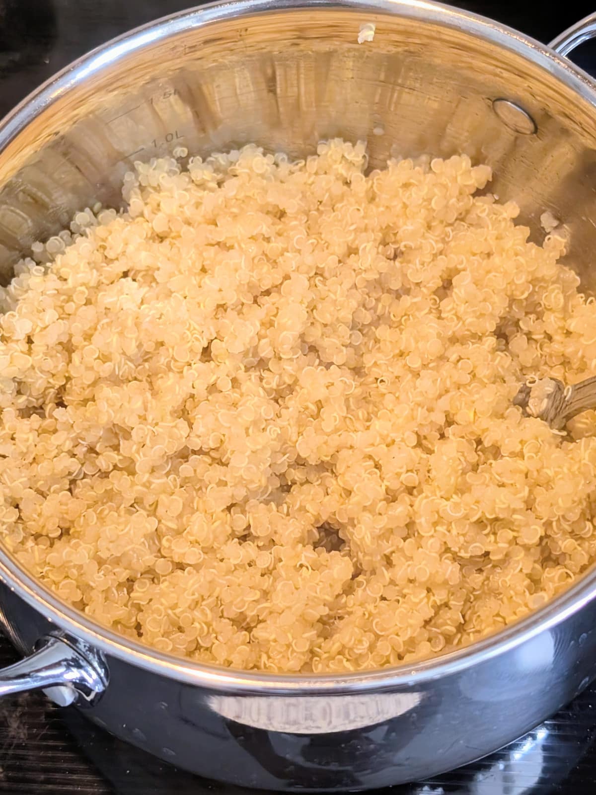 cooked quinoa in a stainless steel pot.
