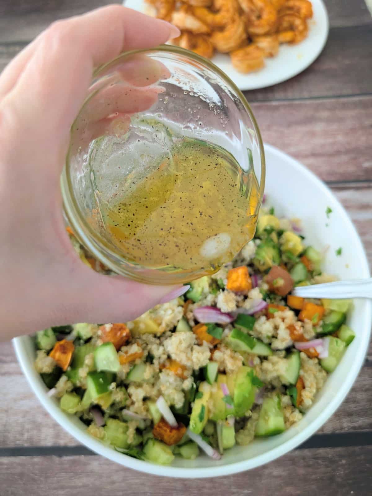 chili lime dressing poured over the shrimp sweet potato quinoa salad.
