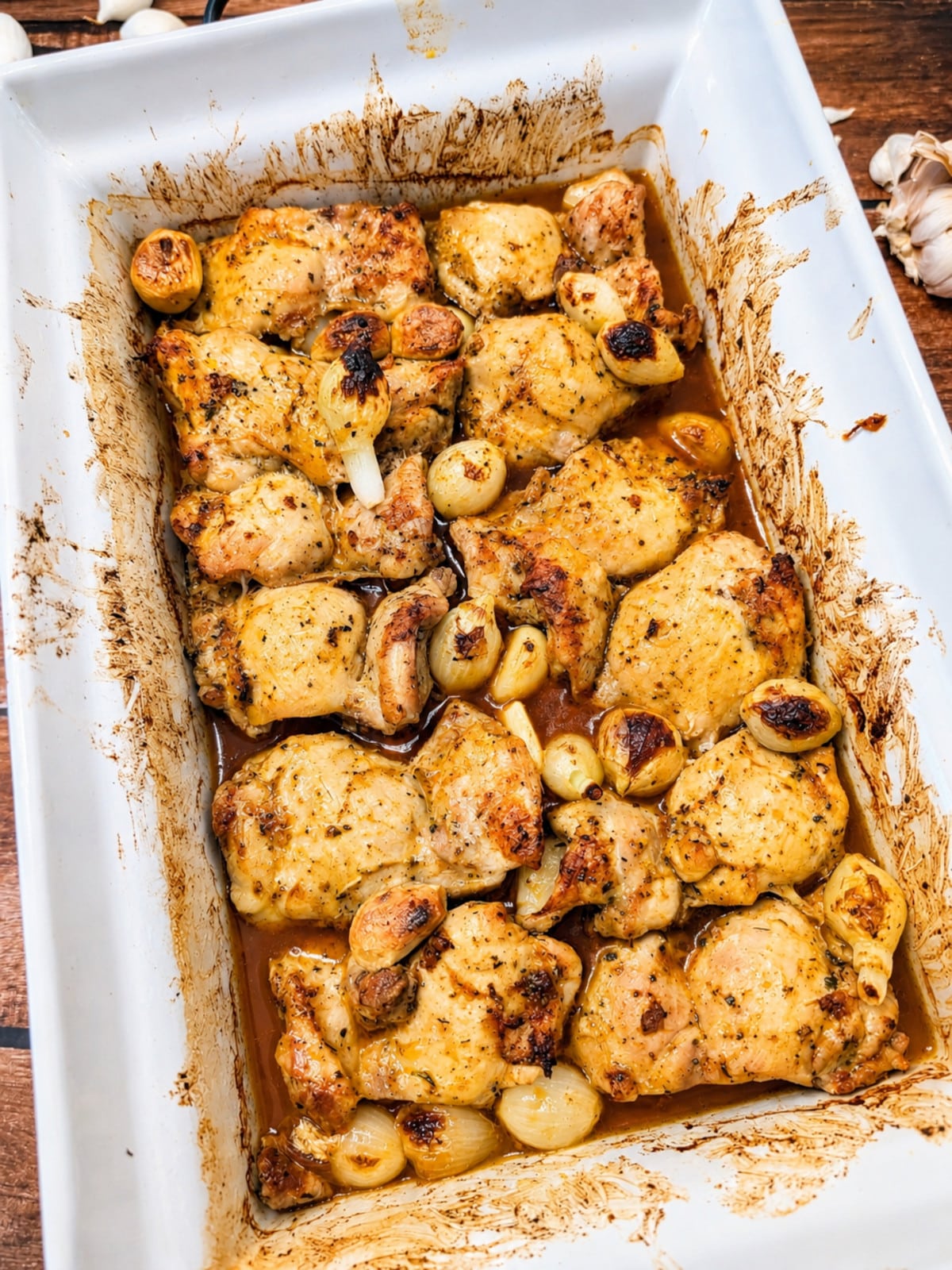 Oven baked chicken thighs with roasted garlic and pearl onions in a buttery pan sauce.