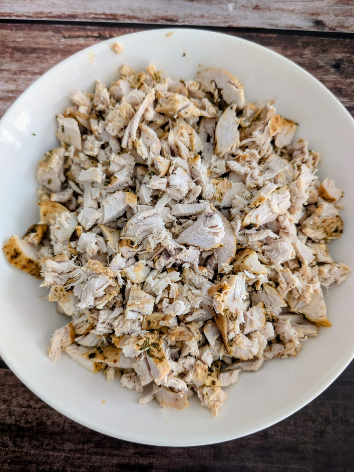 cut up cooked chicken breast in a plate.
