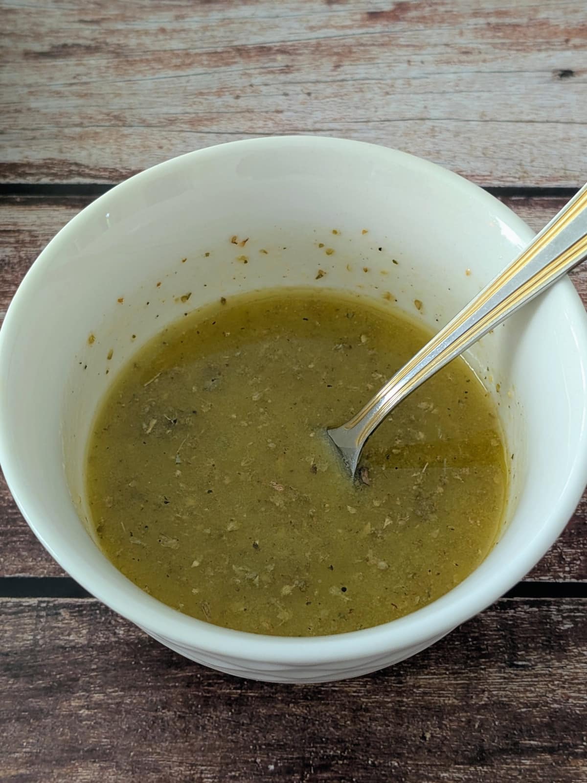 dressing for chicken salad in a small white mixing bowl.
