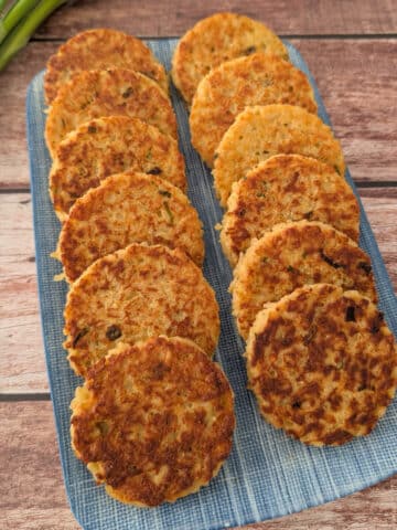 Crispy Rice Fritters served on a blue platter.