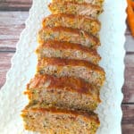 Juicy quinoa zucchini meatloaf sliced and served on platter.