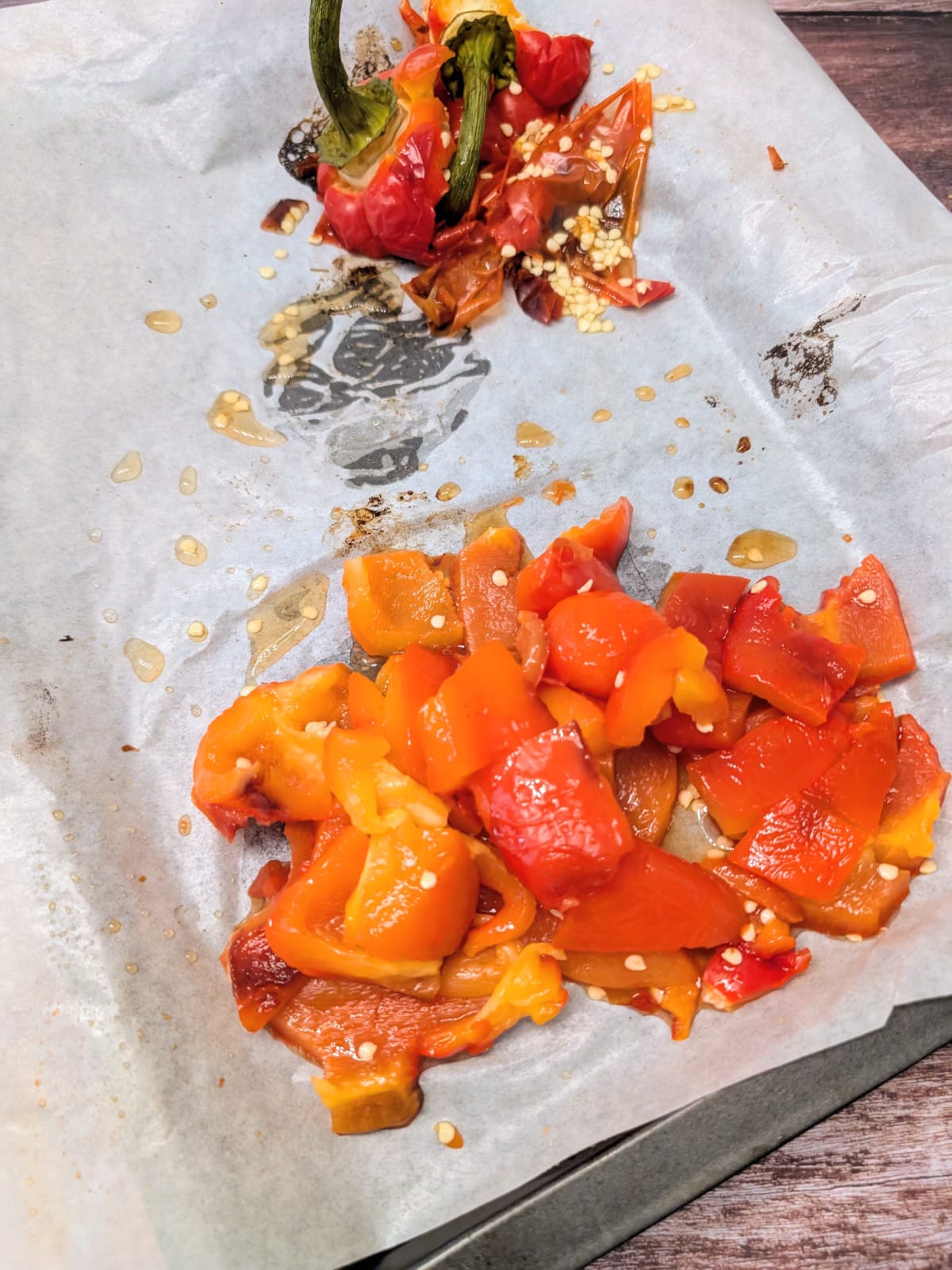 diced roasted red pepper on a parchment paper lined baking dish.