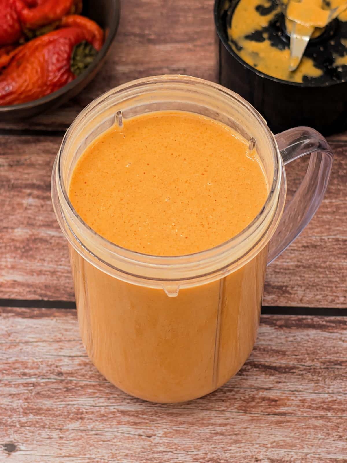 Creamy roasted red pepper Greek yogurt sauce in blender cup.