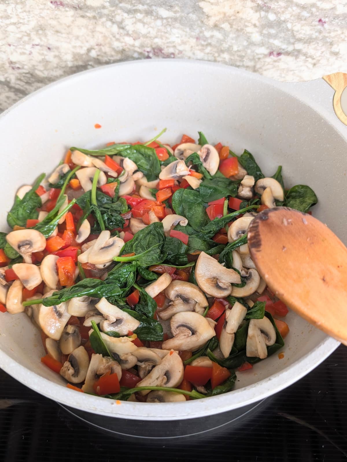Sautéed mushrooms, red pepper and wilted spinach for breakfast strata.